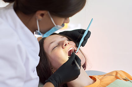 Dental assistant helping prepare patient for sedation