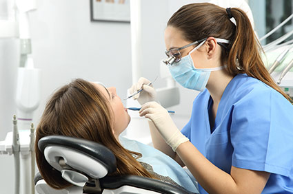 Dental Assistant inspecing patients mouth
