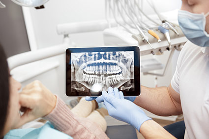 Dentist showing patient their xray